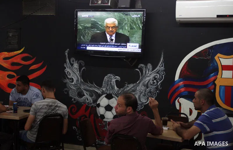 Palestinians watch TV during the speech of Palestinian President Mahmoud Abbas at the at UN headquarters in New York in the 67th session of the United Nations General Assembly, at a cafe in the West Bank city of Ramallah...