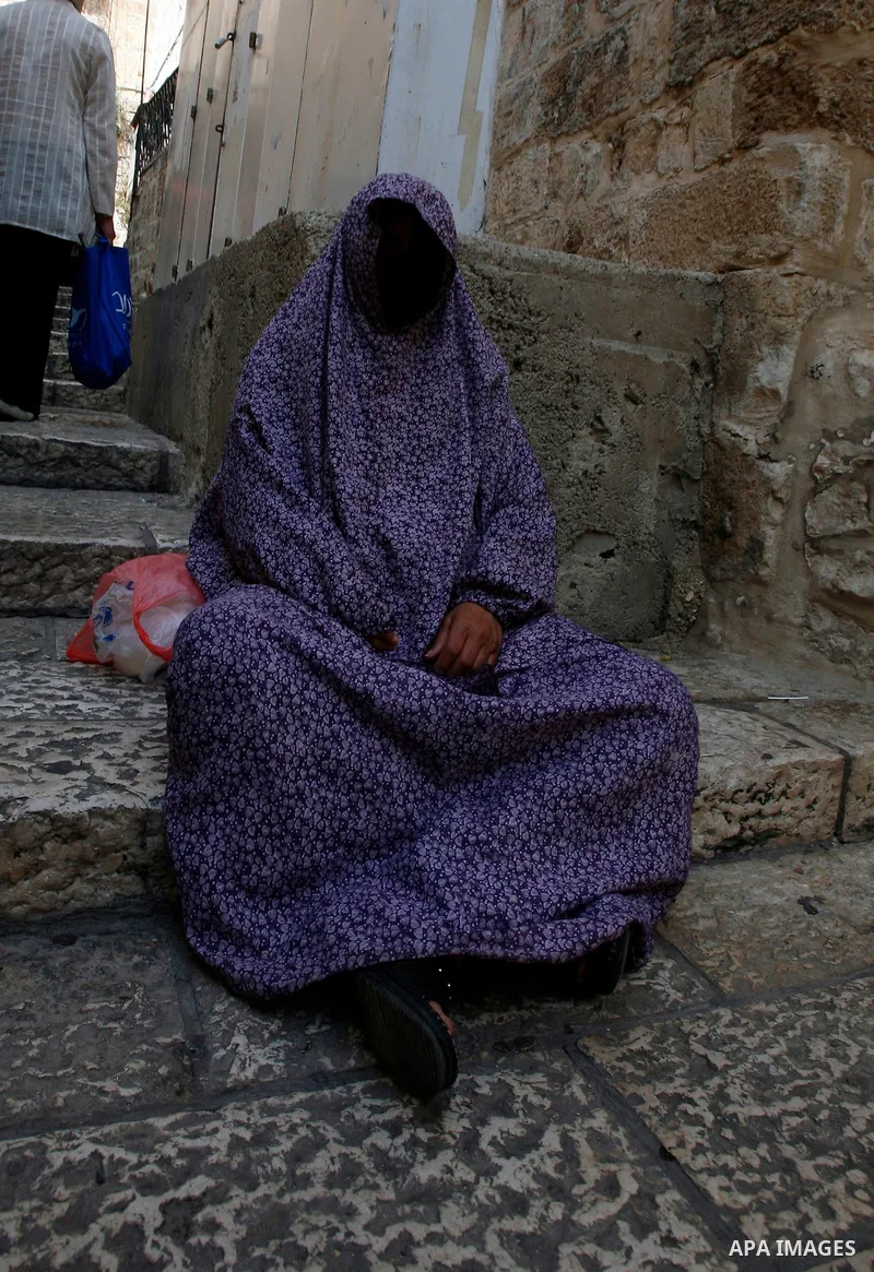 A Palestinan worshiper woman sits in front of the Dome of the Rock Mosque during the Friday prayers at al-Aqsa mosque compound in Jerusalem's old city on September 28, 2012. Photo by Mahfouz Abu Turk