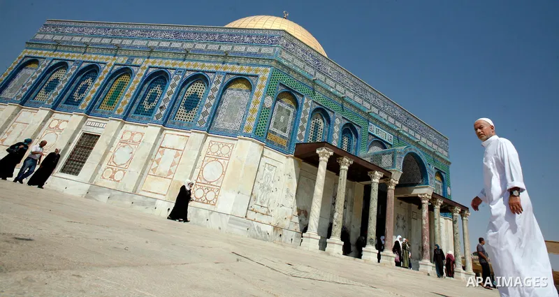 A Palestinan worshiper man walks in front of the Dome of the Rock Mosque during the Friday prayers at al-Aqsa mosque compound in Jerusalem's old city on September 28, 2012. Photo by Mahfouz Abu Turk