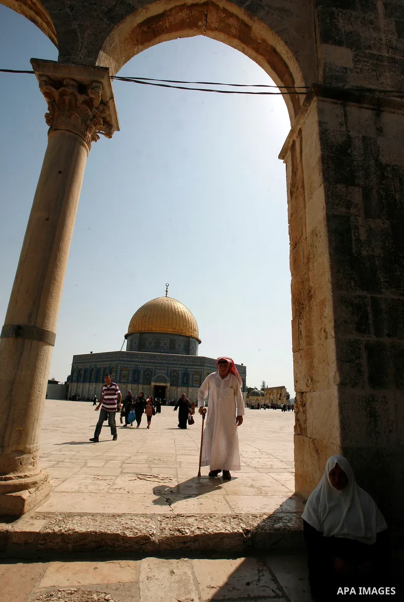 A Palestinan worshiper man walks in front of the Dome of the Rock Mosque during the Friday prayers at al-Aqsa mosque compound in Jerusalem's old city on September 28, 2012. Photo by Mahfouz Abu Turk