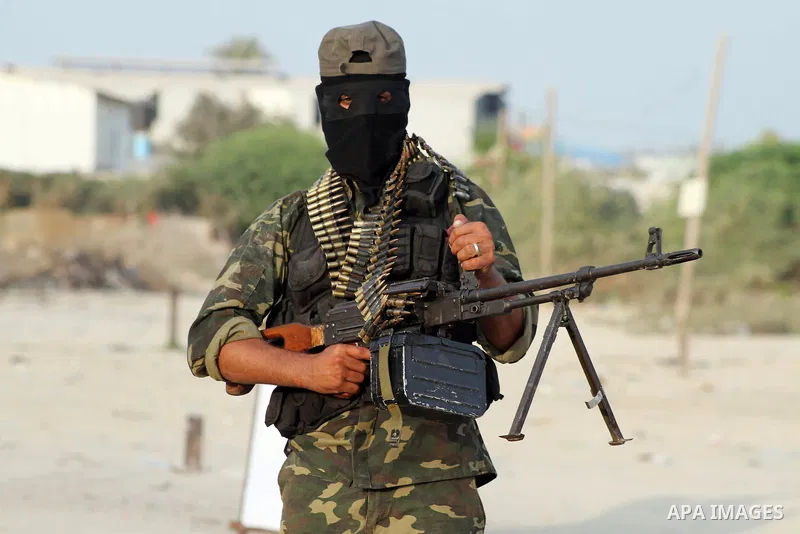 A Palestinian militant from the Al Nasser Brigades, an armed wing of the Popular Resistance Committees (PRC) holds a weapon during a rally marking the 12th anniversary of the brigades, in Gaza city, Friday, Sept. 28, 201...
