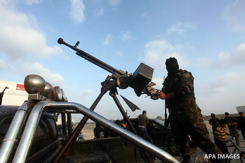 A Palestinian militant from the Al Nasser Brigades, an armed wing of the Popular Resistance Committees (PRC) holds a weapon during a rally marking the 12th anniversary of the brigades, in Gaza city, Friday, Sept. 28, 201...