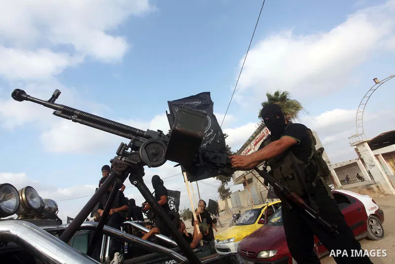 A Palestinian militant from the Al Nasser Brigades, an armed wing of the Popular Resistance Committees (PRC) holds a weapon during a rally marking the 12th anniversary of the brigades, in Gaza city, Friday, Sept. 28, 201...