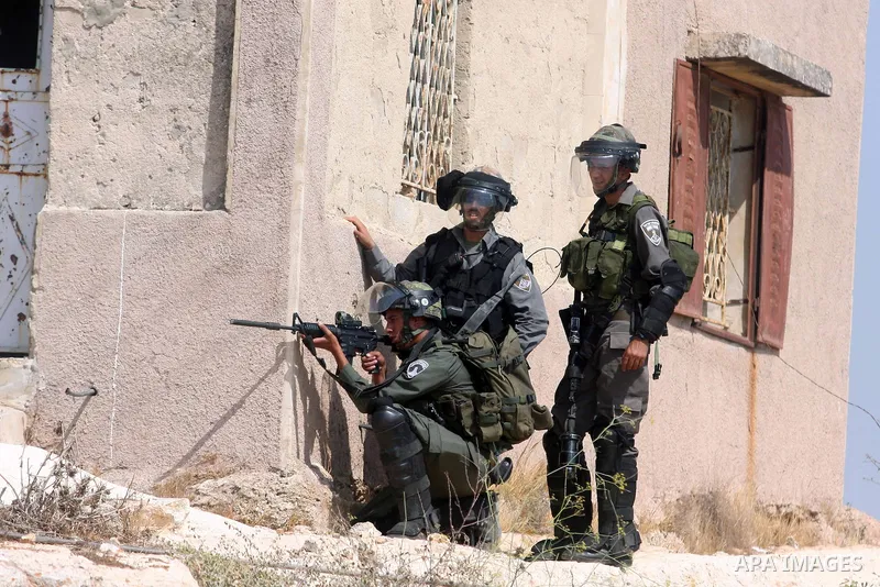 Israeli soldiers fire at Palestinian protesters during a weekly protest against the expansion of the nearby Jewish settlement of Halamish, in the West Bank village of Nabi Saleh near Ramallah, Friday, Sept 28, 2012. Phot...
