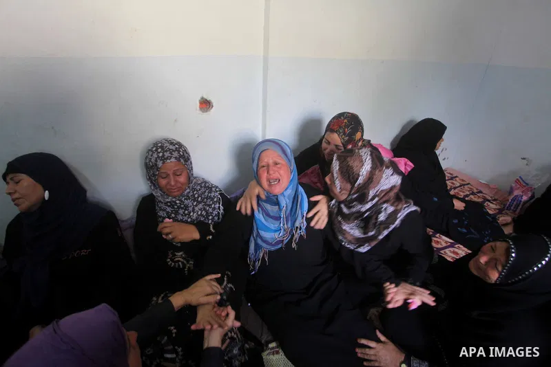 Relatives of Palestinian fisherman Fahmi Abu Rayash mourn over his body during his funeral in Beit Lahia in the northern Gaza Strip on September 29, 2012. Abu Rayash died of his wounds after the Israeli navy opened fire...