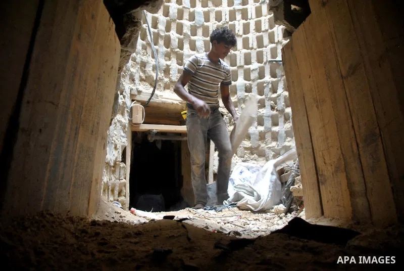 Palestinians work near smuggling tunnels along the border with Egypt in Rafah, southern Gaza Strip, Sunday, Sept. 30, 2012. Hamas officials say that over the past two months, Egypt has closed about 80 percent of the roug...