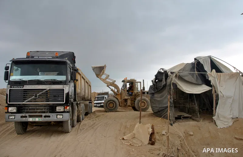 Palestinians work near smuggling tunnels along the border with Egypt in Rafah, southern Gaza Strip, Sunday, Sept. 30, 2012. Hamas officials say that over the past two months, Egypt has closed about 80 percent of the roug...
