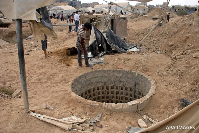 Palestinians work near smuggling tunnels along the border with Egypt in Rafah, southern Gaza Strip, Sunday, Sept. 30, 2012. Hamas officials say that over the past two months, Egypt has closed about 80 percent of the roug...