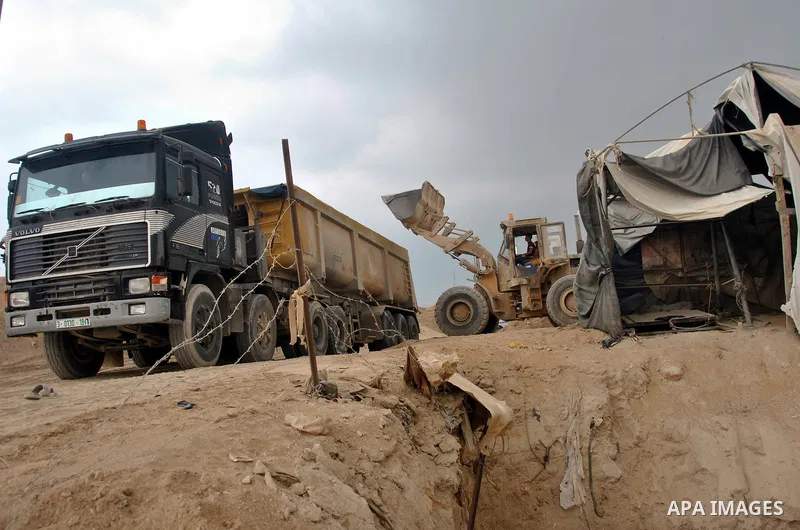 Palestinians work near smuggling tunnels along the border with Egypt in Rafah, southern Gaza Strip, Sunday, Sept. 30, 2012. Hamas officials say that over the past two months, Egypt has closed about 80 percent of the roug...