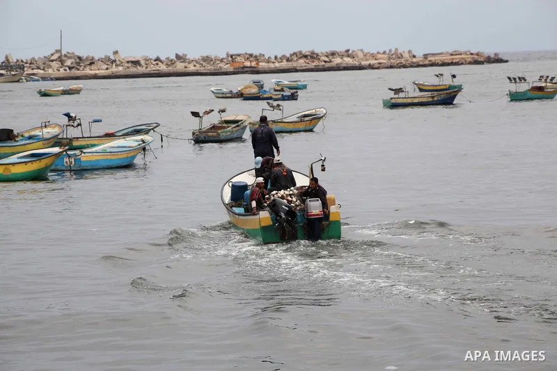 Palestinian fishermen work on their boat at Gaza Seaport in Gaza City September 30, 2012. Israel confines fishermen within a three-mile fishing zone in the Mediterranean Sea off the coast of Gaza, Palestinian fishermen s...