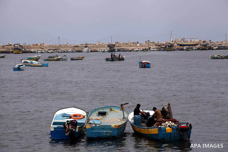 Palestinian fishermen work on their boat at Gaza Seaport in Gaza City September 30, 2012. Israel confines fishermen within a three-mile fishing zone in the Mediterranean Sea off the coast of Gaza, Palestinian fishermen s...