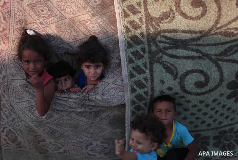 Palestinian refugee children are seen at their makeshift house in a poor suburb in the eastern Gaza City on Sept. 29, 2012. According to local and international humanitarian organization the rate of poverty in the crowde...