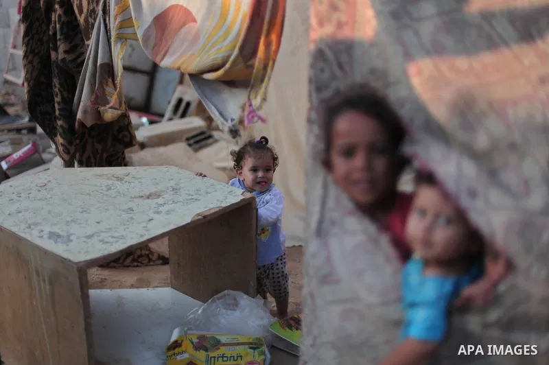Palestinian refugee children are seen at their makeshift house in a poor suburb in the eastern Gaza City on Sept. 29, 2012. According to local and international humanitarian organization the rate of poverty in the crowde...