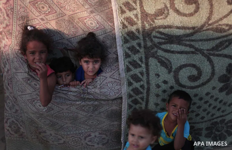 Palestinian refugee children are seen at their makeshift house in a poor suburb in the eastern Gaza City on Sept. 29, 2012. According to local and international humanitarian organization the rate of poverty in the crowde...