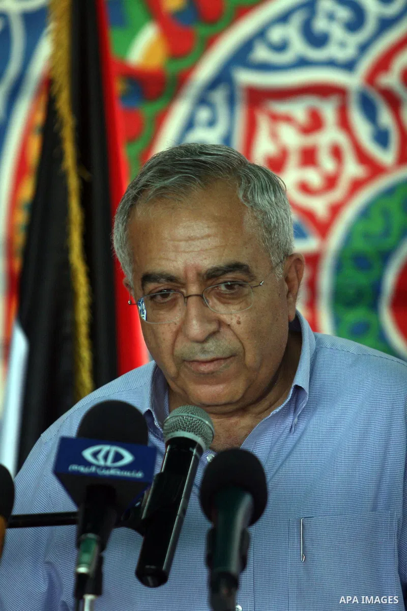 Palestinian Prime Minister Salam Fayyad speaks to the press during a visit to the solar power station in the West Bank city of Jericho on September 30, 2012. Photo by Issam Rimawi