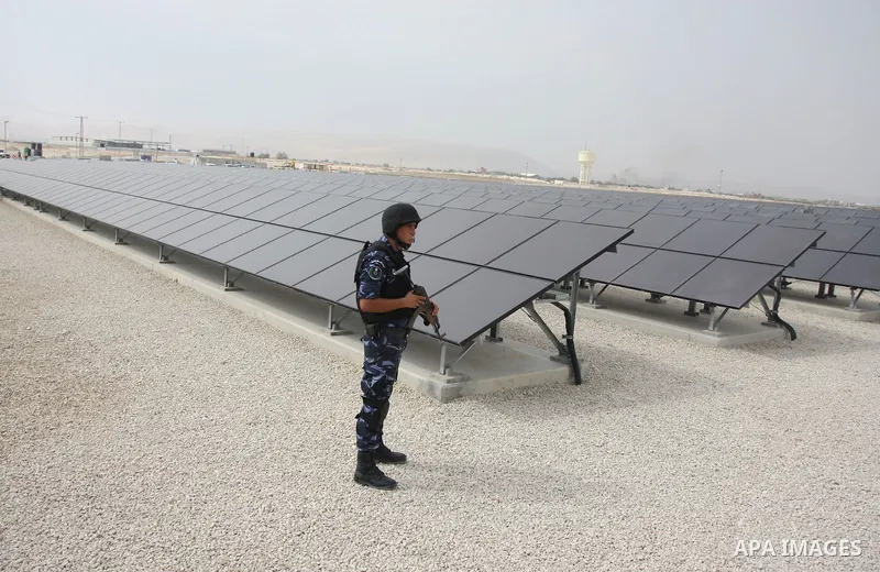 A Palestinian security officer stands guard near the solar power station in the West Bank city of Jericho on September 30, 2012. Photo by Issam Rimawi