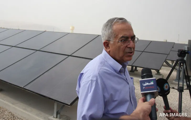 Palestinian Prime Minister Salam Fayyad speaks to the press during a visit to the solar power station in the West Bank city of Jericho on September 30, 2012. Photo by Issam Rimawi