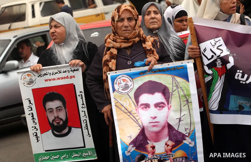 Palestinian women hold pictures of their relatives prisoners held in Israeli jails during a rally calling for their release in front of the red cross office in Gaza city October 1, 2012. Photo by Majdi Fathi