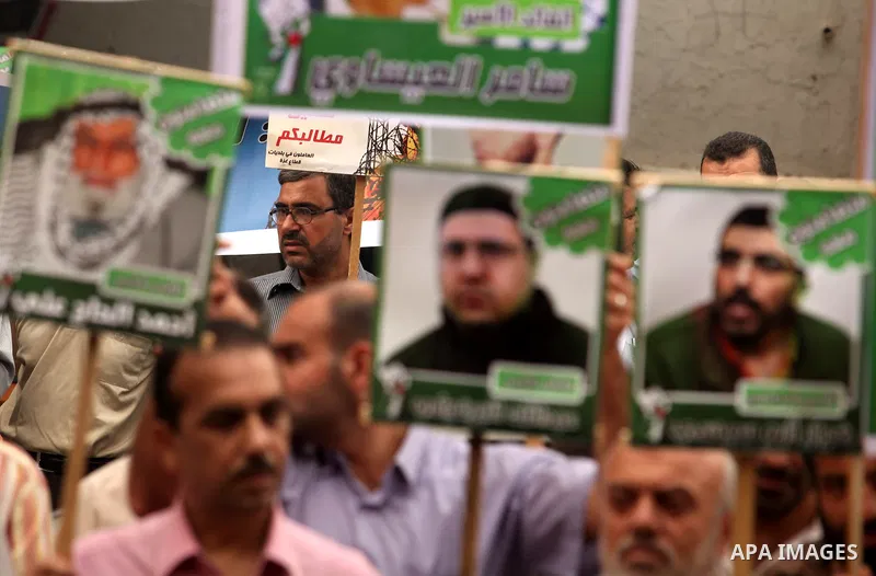 Palestinians hold pictures of their relatives prisoners held in Israeli jails during a rally calling for their release in front of the red cross office in Gaza city October 1, 2012. Photo by Majdi Fathi