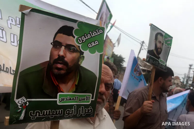 Palestinians hold pictures of their relatives prisoners held in Israeli jails during a rally calling for their release in front of the red cross office in Gaza city October 1, 2012. Photo by Majdi Fathi