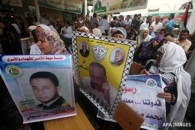 Palestinian women hold pictures of their relatives prisoners held in Israeli jails during a rally calling for their release in front of the red cross office in Gaza city October 1, 2012. Photo by Majdi Fathi