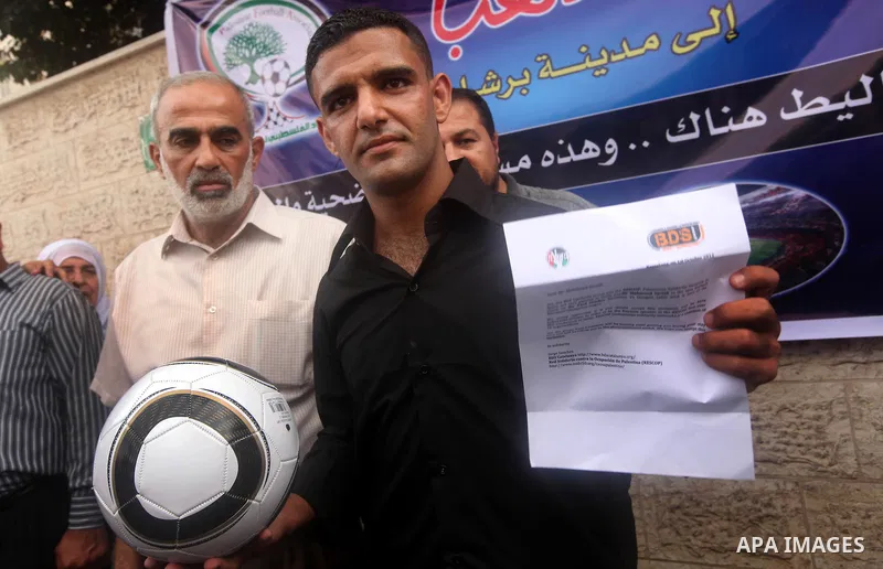 Mahmud Sarsak, Palestinian football player and former prisoner in Israel, holds a ball during a press conference outside the Red Crescent headquarters in Gaza City on October 1, 2012. Sarsak, a former prisoner who went o...