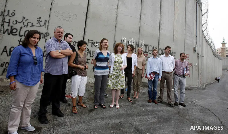Members of European parliamentary delegation pose to camera during a visit to the separation barrier near Abu Dis in south Jerusalem on october 1, 2012. Photo by Mahfouz Abu Turk