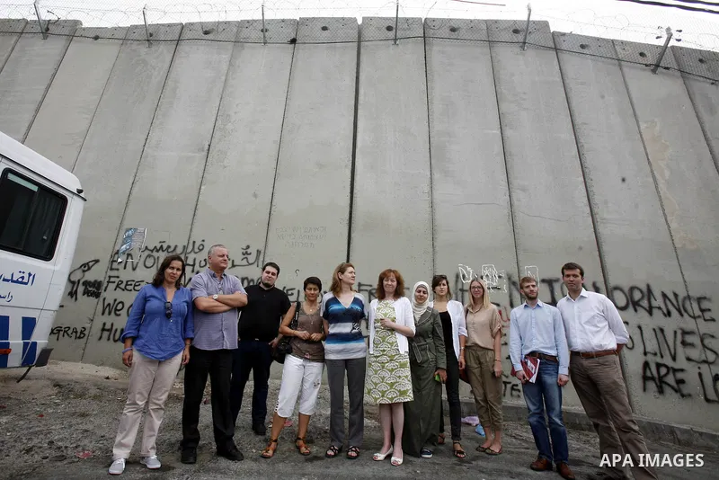 Members of European parliamentary delegation pose to camera during a visit to the separation barrier near Abu Dis in south Jerusalem on october 1, 2012. Photo by Mahfouz Abu Turk