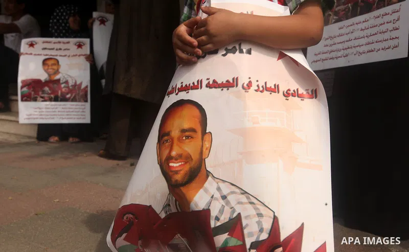 A Palestinian child holds a portrait of Palestinian prisoners held in Israeli jails during a rally calling for their release, in Gaza city on october 2, 2012. Photo by Majdi Fathi