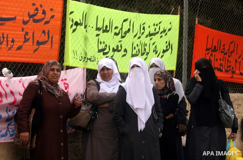 Palestinian employees protest outside the Palestinian Cabinet office against the government decision to dismiss them from their job because of their political affiliation, in the West Bank city of Ramallah on October 1,...