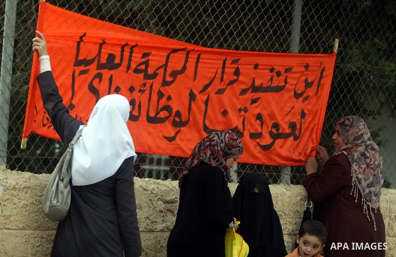 Palestinian employees protest outside the Palestinian Cabinet office against the government decision to dismiss them from their job because of their political affiliation, in the West Bank city of Ramallah on October 1,...