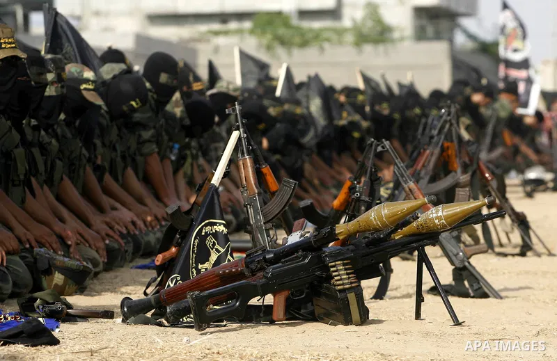 Palestinian militants from the Islamic Jihad, an armed wing of the Al-Quds Brigades Pray during a rally marking the 25th anniversary of the Jihad movement's establishment in Rafah in the southern Gaza Strip on October 2,...