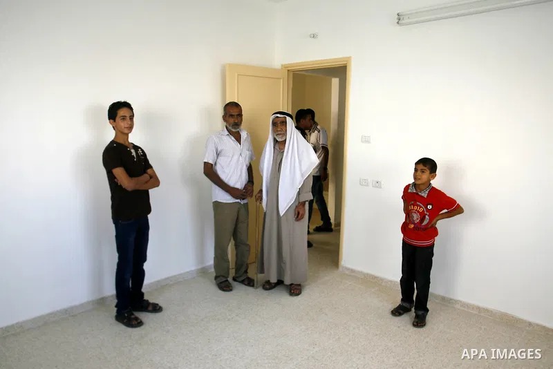 Palestinians walk in their new houses in a project funded by the United Nations Relief and Works Agency for Palestine Refugees (UNRWA) in Rafah, in the southern of Gaza Strip on Oct. 03, 2012. Palestinians whose houses w...