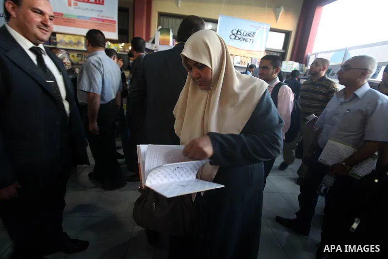 A Palestinian visitor reads a book at a booth during the launch of the International Book Fair Exhibition, in Gaza city , Oct. 03, 2012. The Gaza International Book Fair has participated with more than 70 publishers from...