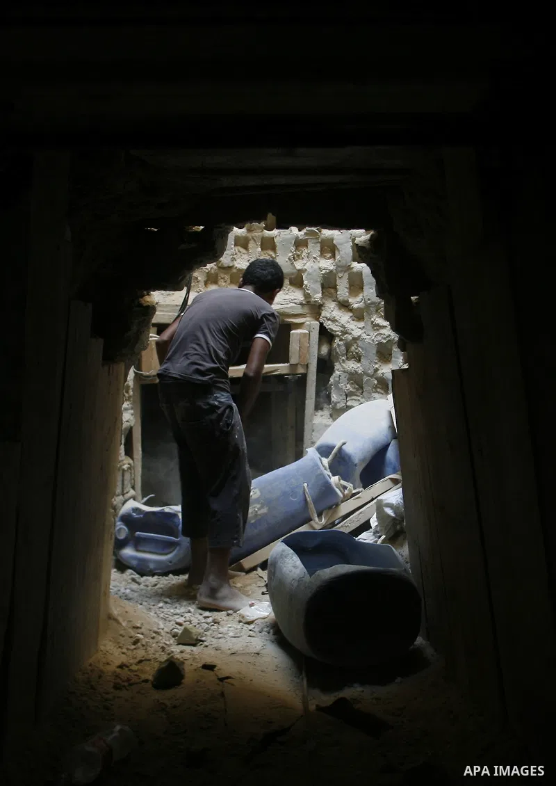 A Palestinian smuggler holds a barrel in a tunnel along the Gaza-Egypt border in Rafah, in the southern Gaza Strip on Oct. 04, 2012. Since last month, Egyptian military have destroyed about 30 tunnels and blocked more wh...