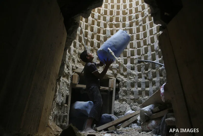 A Palestinian smuggler holds a barrel in a tunnel along the Gaza-Egypt border in Rafah, in the southern Gaza Strip on Oct. 04, 2012. Since last month, Egyptian military have destroyed about 30 tunnels and blocked more wh...