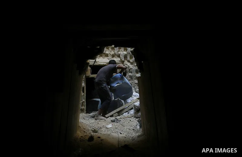 A Palestinian smuggler holds a barrel in a tunnel along the Gaza-Egypt border in Rafah, in the southern Gaza Strip on Oct. 04, 2012. Since last month, Egyptian military have destroyed about 30 tunnels and blocked more wh...