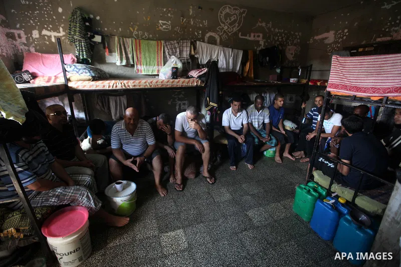 Palestinian prisoners sit in their cell in the Hamas-run Ansar prison in Gaza City on October 4, 2012. The jail holds prisoners convicted of all types of offenses. Human Rights Watch accused Gaza's ruling Hamas movement...