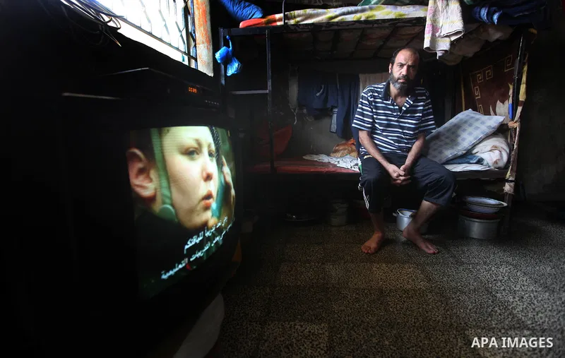 A Palestinian prisoner watches TV in a cell in the Hamas-run Ansar prison in Gaza City on October 4, 2012. The jail holds prisoners convicted of all types of offenses. Human Rights Watch accused Gaza's ruling Hamas movem...
