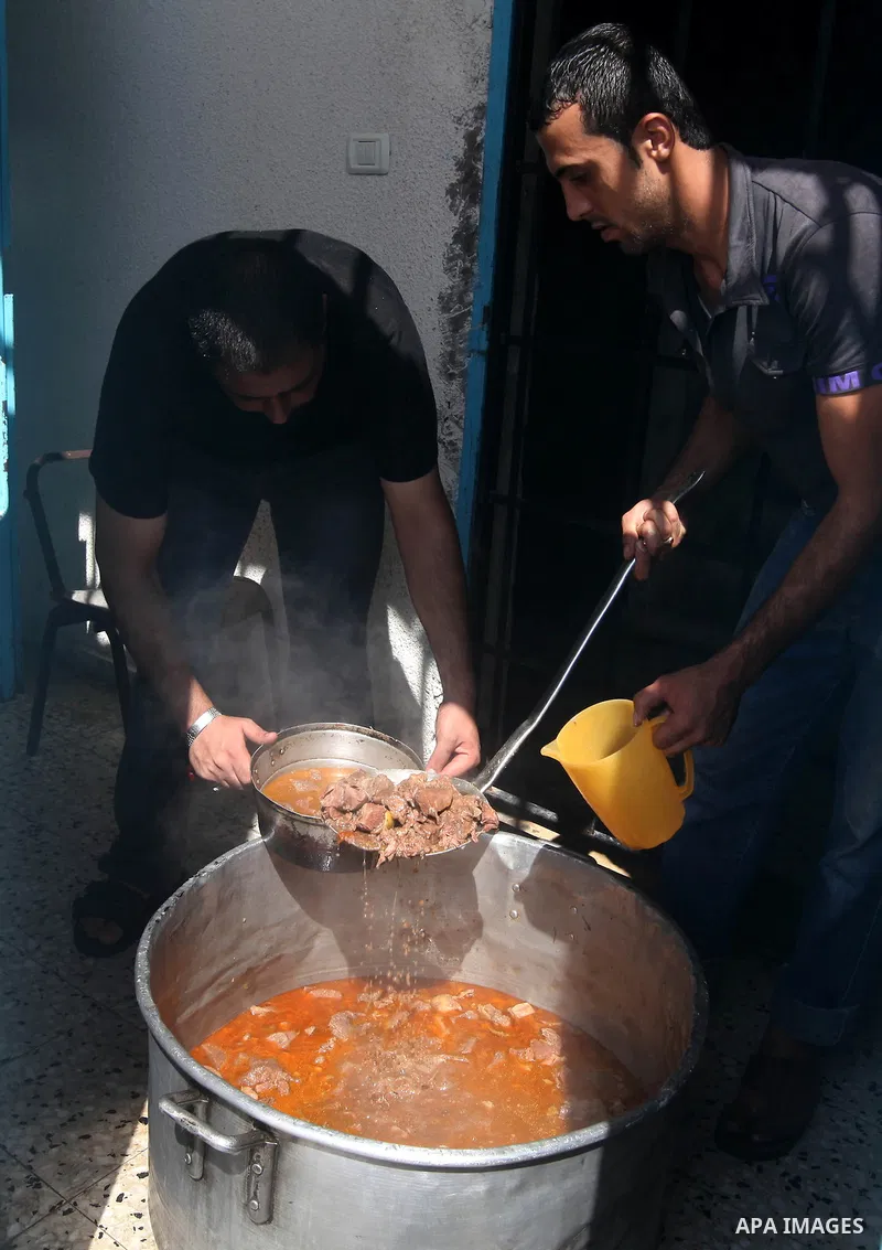 Food is dished out to Palestinian prisoners in the Hamas-run Ansar prison in Gaza City on October 4, 2012. The jail holds prisoners convicted of all types of offenses. Human Rights Watch accused Gaza's ruling Hamas movem...
