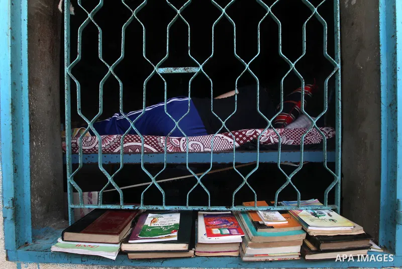 A Palestinian prisoner reads in a cell in the Hamas-run Ansar prison in Gaza City on October 4, 2012. The jail holds prisoners convicted of all types of offenses. Human Rights Watch accused Gaza's ruling Hamas movement o...