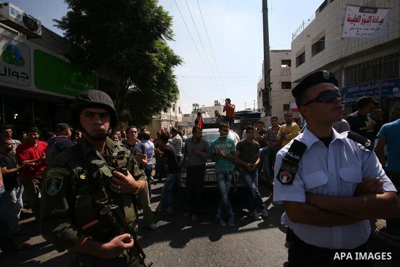 Palestinian police officers stop protesters during a demonstration against Prime Minister Salam Fayyad and the high cost of living in the West Bank city of Hebron on Oct. 4, 2012. The Palestinian Authority is undergoing...
