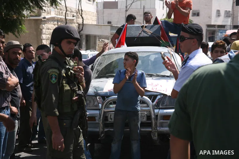 Palestinian police officers stop protesters during a demonstration against Prime Minister Salam Fayyad and the high cost of living in the West Bank city of Hebron on Oct. 4, 2012. The Palestinian Authority is undergoing...