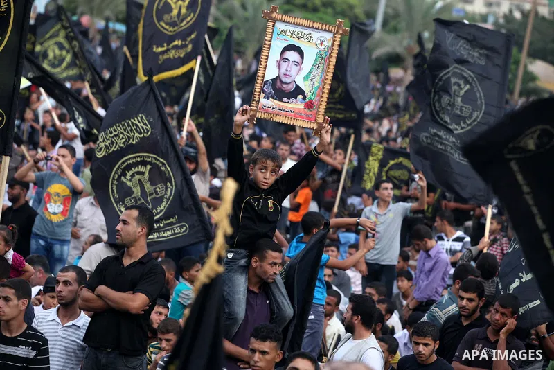 Palestinian supporters of Islamic Jihad movement take part in a ceremony marking the 25th anniversary of the movement's establishment and the 17th anniversary of the death of the group's leader Fathi Shekaki in Gaza City...