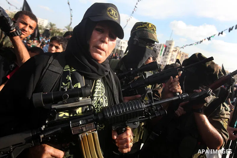 Female Islamic Jihad militants hold weapons during a ceremony marking the 25th anniversary of the movement's establishment and the 17th anniversary of the death of the group's leader Fathi Shekaki in Gaza City October 4,...