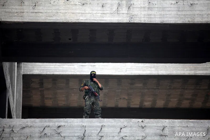 An Islamic Jihad militant stands guard during a ceremony marking the 25th anniversary of the movement's establishment and the 17th anniversary of the death of the group's leader Fathi Shekaki in Gaza City October 4, 2012...