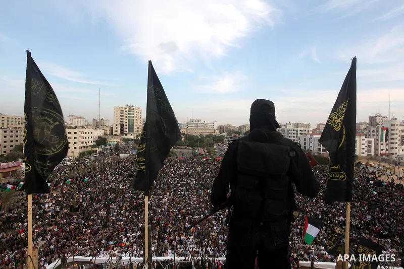 An Islamic Jihad militant stands guard during a ceremony marking the 25th anniversary of the movement's establishment and the 17th anniversary of the death of the group's leader Fathi Shekaki in Gaza City October 4, 2012...