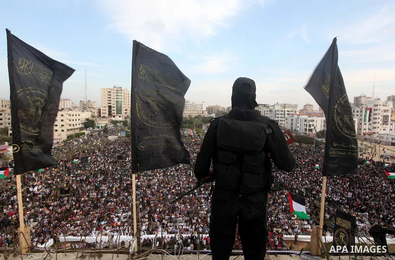 An Islamic Jihad militant stands guard during a ceremony marking the 25th anniversary of the movement's establishment and the 17th anniversary of the death of the group's leader Fathi Shekaki in Gaza City October 4, 2012...