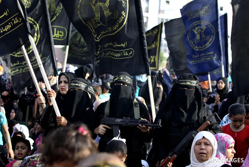 Palestinian female Islamic Jihad militants stand guard during a ceremony marking the 25th anniversary of the movement's foundation and the 17th anniversary of the death of the group's leader Fathi Shekaki in Gaza City Oc...