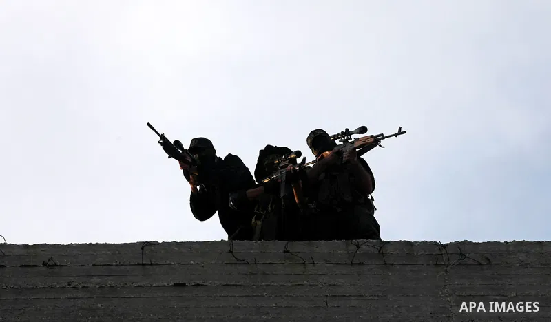 Islamic Jihad militants stand guard during a ceremony marking the 25th anniversary of the movement's foundation and the 17th anniversary of the death of the group's leader Fathi Shekaki in Gaza City October 4, 2012. Phot...